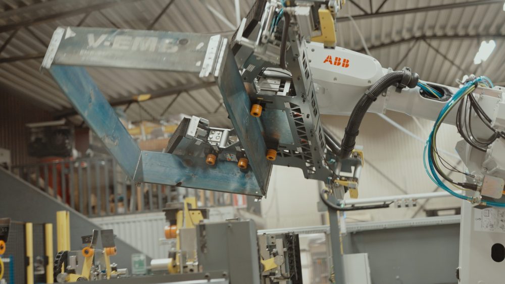 Gray robotic arm working in factory